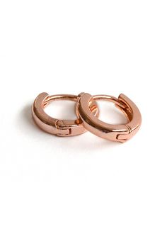 A pair of rose gold plated brass leverback 12mm huggie hoop earrings.  These very small hoop earrings are a classic style with modern details. Details: Huggie hoop earrings - 1 pair Earring size - 12mm Rose gold plated over brass Leverback Made in Turkey Earrings Rose Gold, Small Hoop Earrings, Tassel Bracelet, Huggie Hoop Earrings, Rose Earrings, Rose Gold Earrings, Jewelry Earrings Hoops, Vintage Graphics, Rose Gold Plates