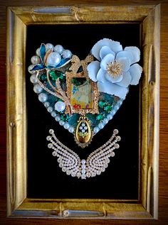 This romantic jewelry art heart is composed of vintage and contemporary jewelry, faux pearls, and clawset rhinestones. In the center of this original artwork is an earring depicting Gustav Klimt's "The Kiss". The floral and pearl design is anchored with a spectacular pearl and rhinestone angel wing brooch. Framed in a 4"x6" antique gold bamboo design frame which has a built in easel... no glass.  Unique and stunning, this one of a kind piece was created with love and attention to detail! Victorian Rhinestone Jewelry For Anniversary, Victorian Jewelry With Rhinestones For Anniversary, One Of A Kind Heart Shaped Vintage Jewelry, One-of-a-kind Heart-shaped Vintage Jewelry, Artistic Wedding Brooch Jewelry, Artistic Wedding Jewelry Brooch, Artistic Wedding Jewelry With Brooch, Victorian Rhinestone Jewelry Gift, Victorian Rhinestone Jewelry For Gifts