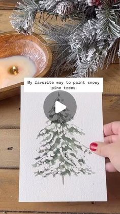 someone is holding up a card with a christmas tree on it and the text reads, my favorite way to paint snowy pine trees