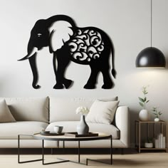 an elephant with swirls on its back is mounted to the wall in this living room