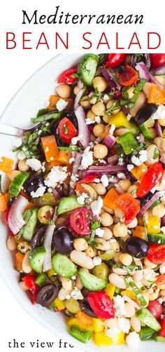 mediterranean bean salad with feta cheese and olives in a white bowl on a table