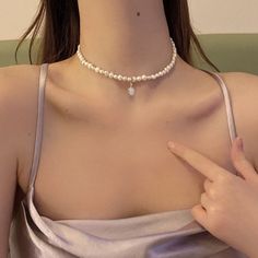 Sweet baroque pearl necklace At first sight, this baroque pearl choker can make people directly feel the meaning of sweet, delicate, and elegant. If you're looking for a real pearl necklace to go with your off-the-shoulder dress, square-neck tee, or anything without a collar, this is the right pearl necklace for women to wear. With a small but noticeable size, this 5-6mm baroque freshwater pearl necklace looks shiny and personal. The baroque pearl choker also comes with an eye-catching design: a Pearl White Choker With Pearl Pendant, White Baroque Pearl Necklace With Clavicle Chain, Dainty White Pearl Pendant Choker, Dainty Baroque Pearl Necklace In Pearl White, Pearl White Baroque Pearl Choker Necklace, Baroque Pearl Choker Necklace In Pearl White, Pearl White Choker With Pearl Charm, Pearl White Choker Necklace With Pearl Drop, Baroque Pearl White Choker Necklace