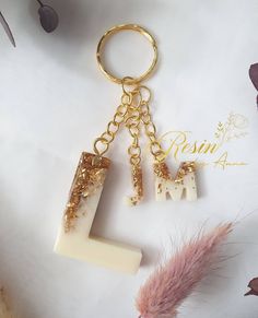 a keychain with two pieces of white and gold on it