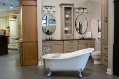 a bathroom with a claw foot tub and two mirrors