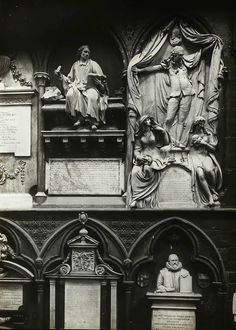 an old black and white photo of some statues