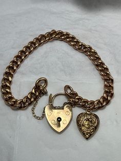 Condition excellent Every link stamped and solid 9ct gold (not hollow) An antique hollow heart charm with full hallmarking  A later yellow gold padlock clasp fully hallmarked fitted with 9ct gold safety chain Small to medium wrist at 17cm Classic Gold Lock Jewelry, Classic Gold Jewelry With Lock Detail, Lock Bracelet Jewelry Gift, Antique Gold Bracelet With Lobster Clasp, Vintage Gold Lock Jewelry, Classic Gold Charm Bracelet With Heart, Vintage Gold Jewelry With Lock, Victorian Curb Chain Jewelry Gift, Victorian Jewelry With Curb Chain As A Gift