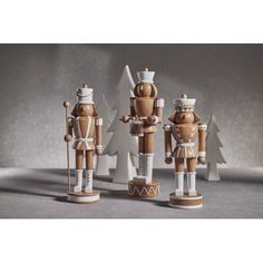 three wooden nutcrackers standing next to each other