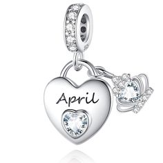 a heart shaped charm with the word apru on it and two hearts attached to it