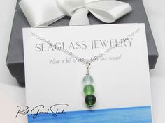 "A lovely handmade-to-order green sea glass beaded bar pendant necklace with beautiful, subtle color variations. The sea glass colors are emerald green, tropical green, and minty seafoam (aqua green / blue). The 6mm beads are round with an ethereal frosty sheen and wire-wrapped to create a pendant measure 1-3/8\" long. The beach glass pendant is suspended from to a dainty cable chain with spring ring clasp, in your preferred length of 16\", 18\", 20\", or 22\" long. Available in your choice of s Green Beaded Necklaces With Recycled Glass For Gifts, Green Recycled Glass Beaded Necklaces For Gifts, Green Recycled Glass Beaded Necklace As Gift, Green Recycled Glass Beaded Necklace Gift, Ombre Necklace, Beach Glass Necklace, Sea Glass Colors, Bar Pendant Necklace, Sea Glass Bracelet