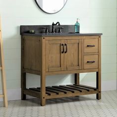 a bathroom vanity with two drawers and a mirror above it