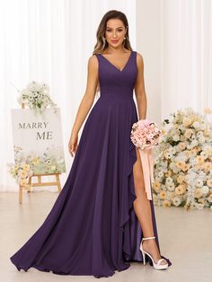 a woman in a purple dress posing for the camera