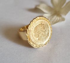 Gold coin ring, coin pinky ring, gold signet ring, coin signet ring, cocktail ring vintage style coin ring, vintage gold ring, pinky ring This gold coin ring is made of a British 5p coin which was decorated with braided gold filled wires and attached to a wide handmade band, creating a lovely signet ring. The coin coin ring is designed in a vintage style and is available both in 14k gold plating over brass or silver as well as sterling silver (see last photo). The ring is a great cocktail ring a Gold Coin-shaped Engraved Ring, Vintage Coin Signet Ring As Gift, Vintage Coin Shaped Signet Ring Gift, Vintage Coin Signet Ring For Gift, Elegant Engraved Coin Rings, Vintage Engraved Coin Signet Ring, Gold Coin-shaped Engraved Signet Ring, Gold Engraved Coin Signet Ring, Vintage 14k Gold Coin Ring