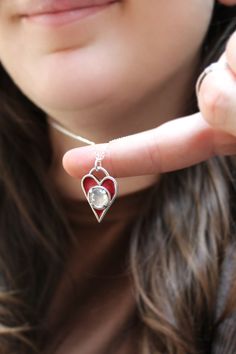 This finely crafted sterling silver heart necklace has three layers of red enamel that is kiln fired to the surface at 1400 degrees. This makes for a durable waterproof and vibrant pendant. I finish it off with a prong set 8mm pink white topaz gemstone. This also has a layered heart detail along with my makers mark on the reverse side. The pendant comes on an adjustable sterling silver chain that can be clasped anywhere between 16 and 20 inches. I ship USPS First Class with tracking, in a gift b Unique Red Heart Shaped Jewelry, Heart Cut Enamel Jewelry For Gifts, Handmade Heart-shaped Enamel Jewelry, Handmade Enamel Jewelry For Valentine's Day, Red Enamel Jewelry With Gemstone, Red Gemstone Jewelry With Enamel, Valentine's Day Enamel Jewelry Nickel-free, Valentine's Day Nickel-free Enamel Jewelry, Red Sterling Silver Heart Pendant Jewelry