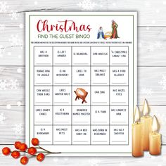 a christmas find the guest bingo game with candles and holly wreaths on a wooden table