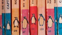 a row of books with penguins on them and numbers painted on the front covers in different colors