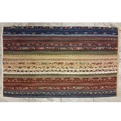 a multicolored rug with many different patterns