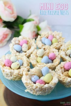 mini egg rice krispies nests on a blue plate with flowers in the background