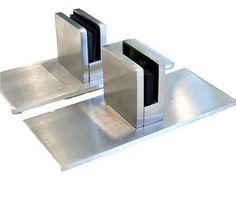 two stainless steel bookends sitting on top of each other