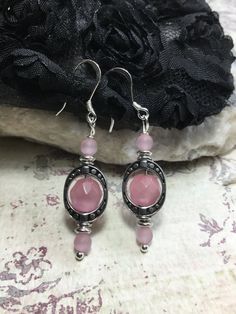 "So Delicate And Pretty These Pink Cats Eye Earrings. Made With, 4mm. Round Matte Pink Cats Eye Stone, 8mm Faceted Round Pink Cats Eye Stones, Antique Silver Plated Ovals, Sterling Silver French Hook Ear Wires And Silver Plated Ball Head Pins. If You Have An Idea For Another Stone Please Let Me Know. Any Item In My Shop Can Be Altered Or Substituted. Cat's Eye acts to stimulate intuition and to enhance awareness. It is a grounding stone that provides a very effective protective energy. Cat's Eye Silver Spiritual Hoop Earrings, Hypoallergenic Round Spiritual Earrings, Spiritual Round Hypoallergenic Earrings, Spiritual Hypoallergenic Round Earrings, Elegant Pink Sterling Silver Teardrop Earrings, Adjustable Pink Teardrop Earrings With Ear Wire, Pink Hypoallergenic Sterling Silver Hoop Earrings, Pink Sterling Silver Hypoallergenic Hoop Earrings, Pink Sterling Silver Drop Crystal Earrings