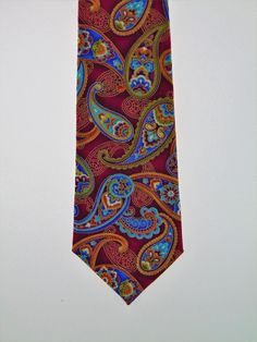 "This cotton print Necktie features a beautiful paisley design with a hint of metallic. Colors include metallic gold, cream, rust, dark rust, gold, beige, shades of blue and purple, green and dark magenta Expertly hand-made from 100% cotton you can select your length from 57\" to 71\" (Great for taller Men). Width is standard 3.5\" as shown here or skinny 2.5\". If you require a custom length or width, please contact us. 2.5\" x 48\" Child size available upon request. Ships within 2 business day Multicolor Paisley Print Suit And Tie Accessories For Business, Elegant Multicolor Paisley Print Suit And Tie Accessories, Elegant Multicolor Paisley Print Ties, Formal Patterned Paisley Suit And Tie Accessories, Formal Patterned Ties With Paisley Print, Formal Multicolor Paisley Suit And Tie Accessories, Classic Paisley Print Patterned Ties, Beige Shades, Purple Gothic