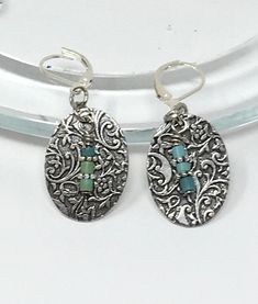 Etched Antiqued Pewter and Turquoise Beaded Earrings - This pair of earrings are made with an etched pewter oval shaped piece with a damask design. In front are three tiny turquoise beads separated by silver rondels. These hang 1 inch from the lever close ear wires. Bohemian Oval Metal Earrings, Bohemian Oval Nickel-free Jewelry, Bohemian Oval Stamped Jewelry, Nickel Free Antique Silver Oval Jewelry, Nickel-free Antique Silver Oval Jewelry, Bohemian Jewelry With Oxidized Finish And Oval Shape, Nickel-free Bohemian Pewter Jewelry, Turquoise Bead Earrings, Damask Design