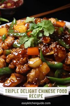 a white plate topped with meat and veggies next to chopsticks on a table