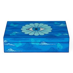 a blue box with an image of a flower on the lid and clouds in the background