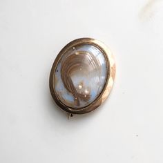 "A Victorian rose gold memorial brooch locket. Inside this locket there is a lock of hair displayed and pearls. A sentimental piece used to remember a loved one with the initials \"SLC\". CONDITION: Wear consistent with age and use. Please see photos for more detail. Some damage to hair and pearls. BROOCH SIZE: 28mm x 35mm WINDOW SIZE: 23mm x 28mm and 24mm x 30mm WEIGHT: 11.7" Brooch Display, Hair Locket, Lock Of Hair, Old Rings, Gold Brooch, Gold Brooches, Antique Roses, Eternity Bands, Diamond Bands