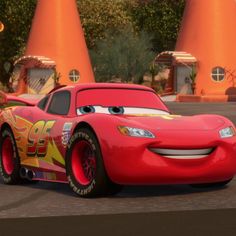 the character cars from disney pixars are in front of some orange cones