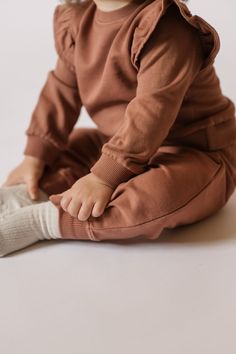 Rediscover our classic French Terry Sweatshirt for baby, with a signature ruffle sleeve. Available in three soft hues with ribbed trim and back snaps for easy on-and-offs, we love it ‘pehr’-ed with our French Terry Harem Pants or Essential Legging for a complete set! Made in 100% organic French Terry cotton, each piece of this collection is garment dyed for a vintage washed look and has the softest hand-feel. Organic Cotton & Dyes Bottom Clothes, French Terry, Harem Pants, Dress Shop, Overalls, Organic Cotton, Kids Outfits, Rompers, Trim