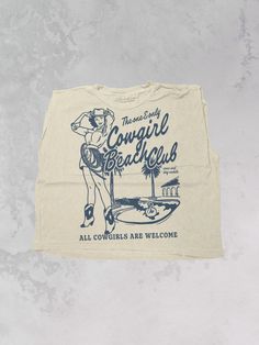 Get all of the southwestern beach vibes in this Cowgirl Beach Club western inspired retro 90's style cropped tank!- Features a Cowgirl standing beside a beach club with the phrase "the one and only Cowgirl Beach Club" and "all cowgirls are welcome" underneath all in a blue ink- Screen print transfer that is heat pressed onto each tshirt - Tshirt is a high quality, garment dyed, vintage wash that gets softer after each wash - Oversized fit - Sizing translation: XS/S - M , S/M - L , L/XL - XL , 2XL/3XL - 2XL - 100% Cotton**due to screens & filters color may vary from pictures** Retro Graphic Print Tank Top For Summer, Sleeveless Cotton Tops For Beach Party, Beach Season Tank Top With Letter Print, Letter Print Tank Top For Beach Season, Summer Music Festival Tank Top With Graphic Print, Tank Top With Graphic Print For Beach Season, Summer Tank Crop Top With Graphic Print, Summer Graphic Print Tank Crop Top, Beach Graphic Print Cotton Tank Top