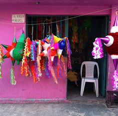 there are many colorful items hanging outside the store