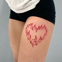 a woman's thigh with tattoos on it