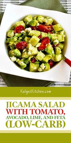 a salad with tomatoes, avocado and feta in a bowl on a table