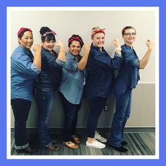 four women in scrubs are posing for the camera with their hands up and smiling