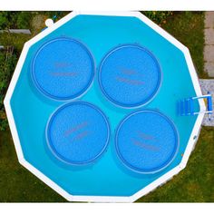 four blue frisbees sitting on top of an above ground pool