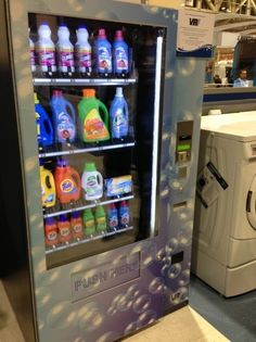 an appliance display in a retail store with cleaning products and laundry detergents