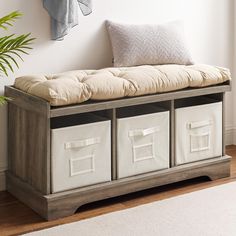 a bench with storage bins underneath it and a plant in the corner next to it