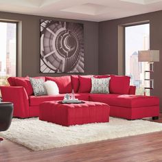 a living room with red couches and white rugs on the wooden flooring