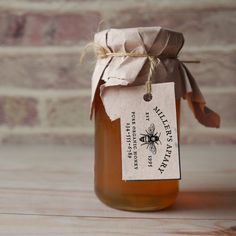 a jar filled with honey sitting on top of a wooden table