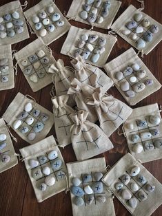 several small bags filled with rocks on top of a wooden table