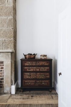 a room with a fireplace and a sign on the wall