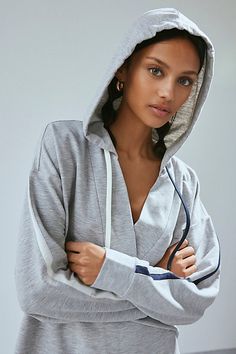 Elevated essential Out From Under X Tommy Hilfiger sweatshirt in a relaxed, slouchy fit. Designed in a super soft fleeced knit featuring a wrap v-neckline, hood with contrast string details and stripes down the sleeves. Find it only at Urban Outfitters. Features Out From Under X Tommy Hilfiger hoodie sweatshirt Lounge pullover sweatshirt Soft & stretchy fleeced knit Wrap v-neckline with hood & string details Stripe details down the sleeves Relaxed, slouchy fit Cropped length Easy pull-over style UO exclusive Content + Care 95% Polyester, 5% spandex Machine wash Imported Size + Fit Model in Navy is 5’7.5" and wearing size Small Measurements taken from size Small Chest: 41" Length: 23.5" | Out From Under,Tommy Hilfiger Out From Under X Tommy Hilfiger Hoodie Sweatshirt in Grey, Women's at Urb Athleisure Hooded Sweatshirt For Lounging, Winter Lounging Top With Drawstring Hood, Relaxed Fit Hooded Loungewear Top, Hooded Relaxed Fit Tops For Loungewear, Relaxed Fit Hooded Top For Loungewear, Sporty Hooded Top With Relaxed Fit, Long Sleeve Athleisure Hoodie For Lounging, Athleisure Long Sleeve Hoodie For Lounging, Sporty Heather Grey Top With Drawstring Hood