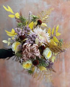 a bridal bouquet with yellow and purple flowers