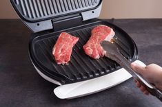 someone is using a grill to cook steaks on the grill