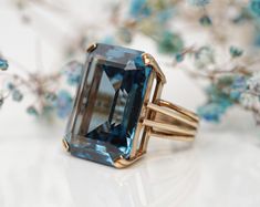 This Stunning Vintage blue Synthetic Spinel ring is a must have! It is 100% handmade and its design looks simple on a first glance but when looking at it closer, its craftsmanship is truly stunning. This ring for those that want to buy the perfect gift:  *For your loved one, to show them that your love for them is as big as this stunning synthetic spinel *For you to widen your jewelry collection  and it's perfect, *If you are someone that wants all eyes on you *Or if you are someone that starts their jewelry collection now. This ring will be your strong start. These are only a few reasons as to why this ring should be yours. Its beautiful basket setting gives all the attention to the stone and the double claws make sure to keep the stone extra secure. The stone is laboratory created. That Handmade Blue Topaz Fine Jewelry Ring, Handmade Blue Topaz Ring In Fine Jewelry Style, Classic Handmade Blue Ring, Classic Handmade Blue Rings, Handmade Blue Topaz Ring For Formal Occasions, Formal Handmade Blue Rings, Ring Upgrade, Jewelry Rendering, Jewelry Emerald