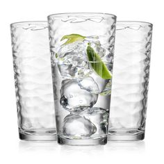 three glasses filled with ice and green leaves