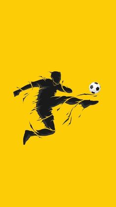 a man kicking a soccer ball on top of a yellow field