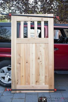 a car parked next to a wooden gate