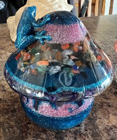 a blue and pink glass container sitting on top of a counter